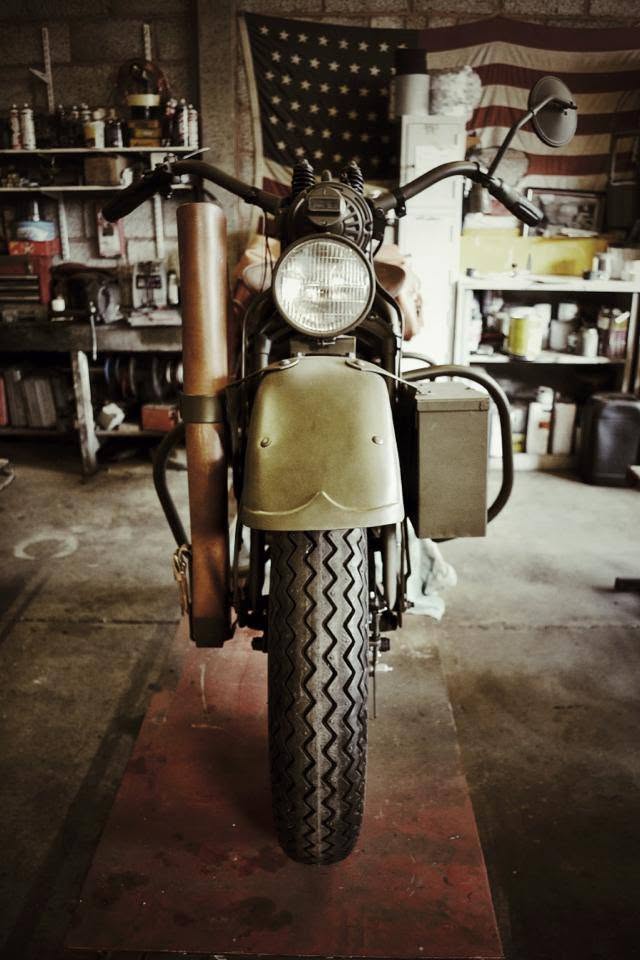 A military Harley-Davidson on a workshop platform